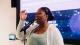 Roshelle Reid singing into a microphone