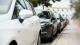 Row of five cars parked along a street