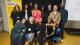 A group of people at a scholarships celebration event in front of a yellow banner reading "Why scholarships matter"