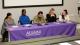 Photo of Sociology panellists on a table with a purple alumni tablecloth
