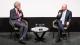 Steve Barnett (left) interviewing Steve Rosenberg (right). They are sat around a small table.
