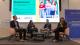 Photo of student panel which features Tom Lowe on the left then the three students next to him. The student on the right is holding a microphone and speaking