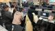 Students gathered around a computer for the short course session with Cognizant
