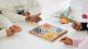 Four people playing a board game.