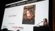 Susie Dent talking at a microphone stand in front of a projector screen with her picture and text reading Charles Wheeler Speaker Susie Dent