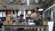 Technicians in a workshop sat at a worktop bench