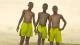 Three black boys standing together wearing shorts