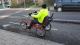 A man riding a three-wheeled bike in a cycle lane.