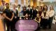 Westminster students at the World Economic Forum in front of a purple banner that reads WESTMINSTER WORKING CULTURES