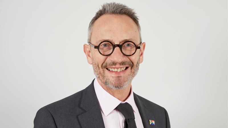 Portrait of Professor Andrew Linn smiling into the camera.