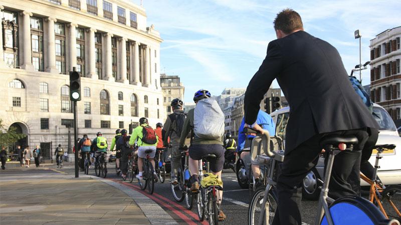 Cyclists on the road in London on a sunny morning