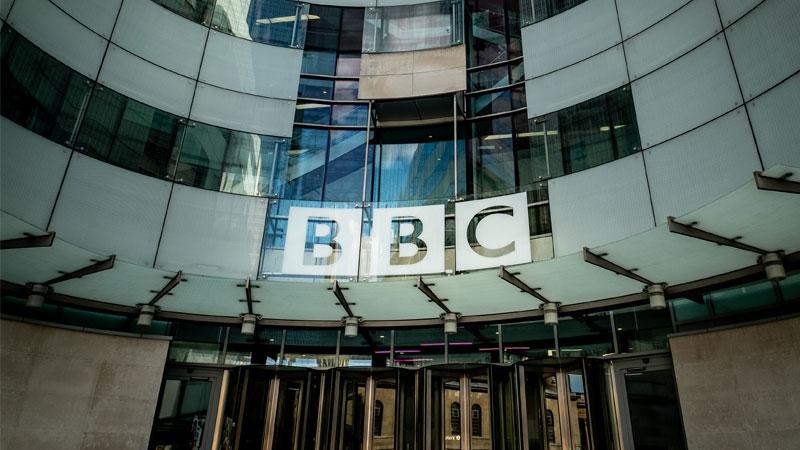 Entrance to the BBC building with the logo written on the glass panels