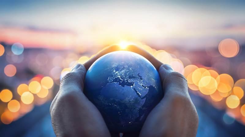 Stock photo of a globe being held in some hands.