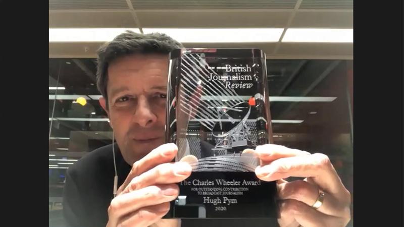 Hugh Pym holding British Journalism Review award 