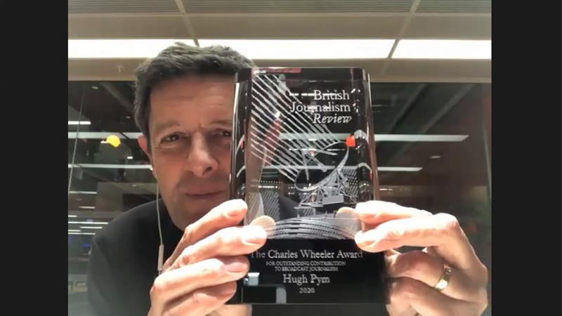 Hugh Pym holding British Journalism Review award
