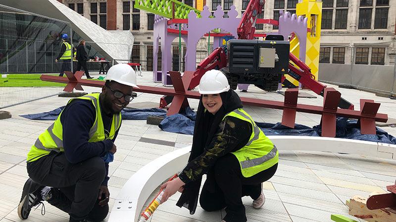 Master of Architecture (MArch) students Blessing Sulaiman and Hana Alsaai helping assemble the Ramadan Pavilion at the V&A.