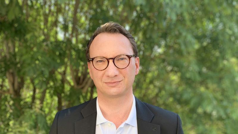 Marco Roscini standing infront of green trees