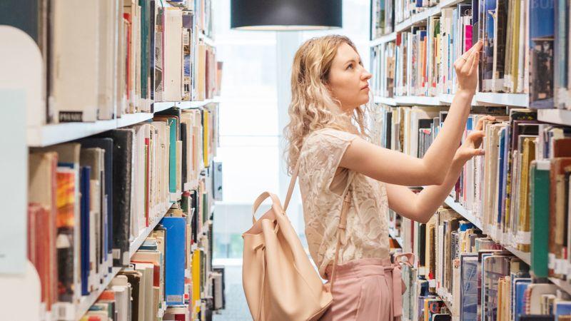 Student searching for a book in Marylebone Library