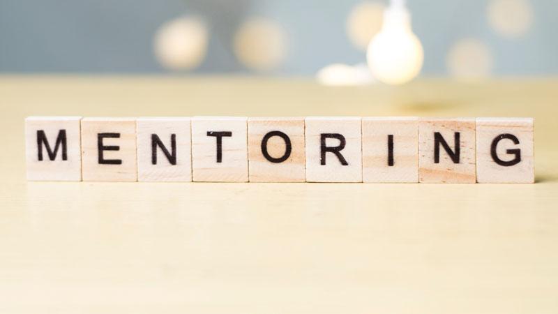 Mentoring word on wooden table