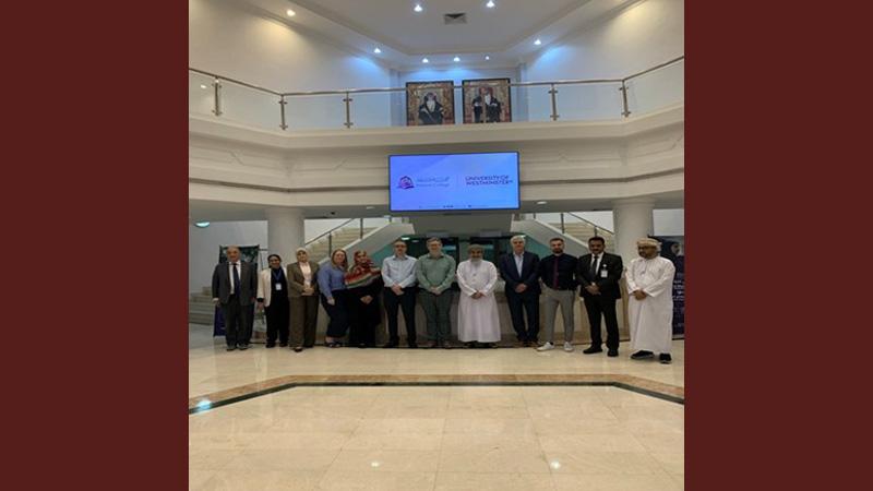 Representatives from the University of Westminster and Muscat College smile for a photo.