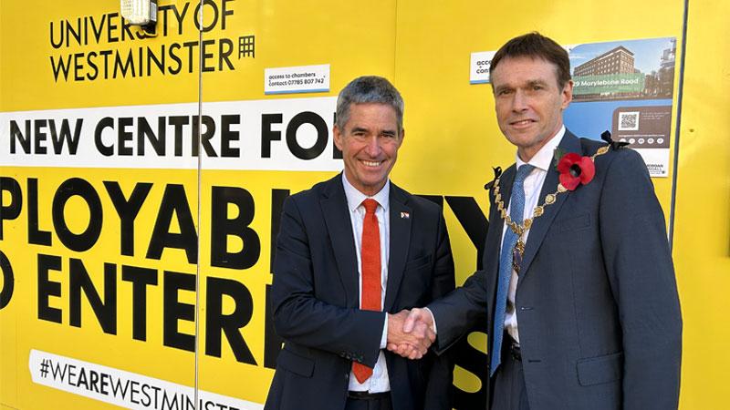 Professor Peter Bonfield and the Lord Mayor of Westminster shake hands in front of the Zone29 site hoarding.
