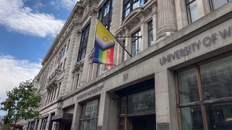 Pride flag flying from Regent Campus facade