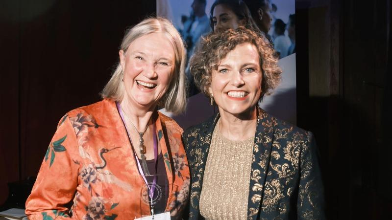 Professor Stroma Cole and Women in Travel (CIC) Founder and Managing Director Alessandra Alonso stand together at an event, with Cole holding an award.