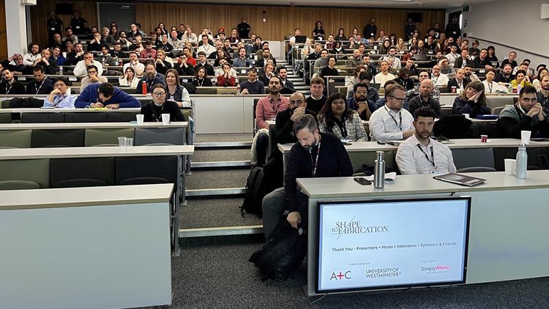 People sat in a lecture theatre at the Shape to Fabrication conference
