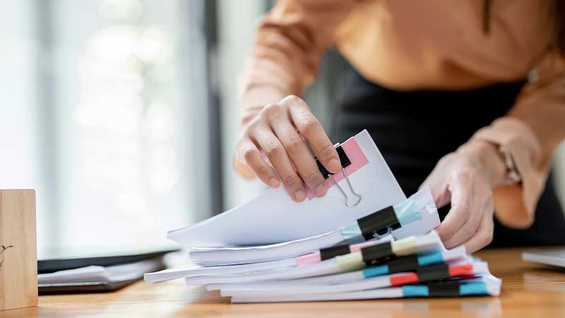 Shutterstock person going through reports photo