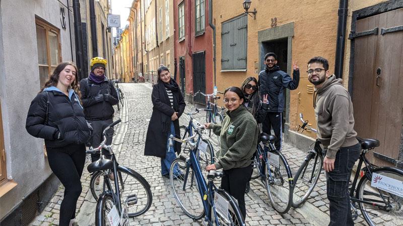 A group of students on bicycles in the streets of Stockholm.