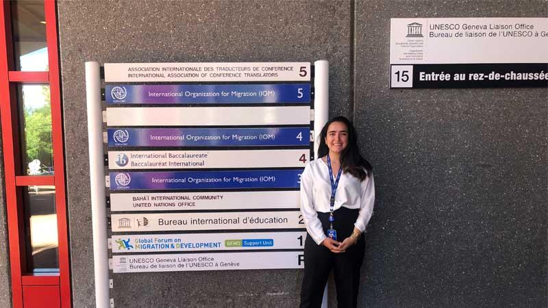 Female student standing in front of IOM Headquarters in Geneva
