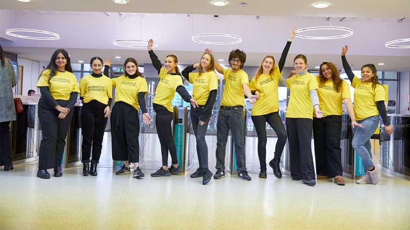 Student ambassadors wearing yellow t-shirts on campus