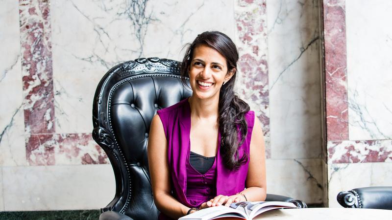 A student reading a book and smiling