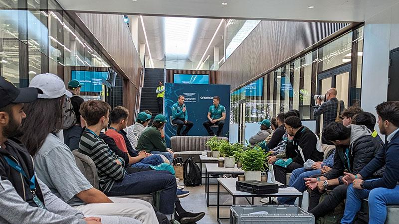 Students watching a panel discussion at the Aston Martin event