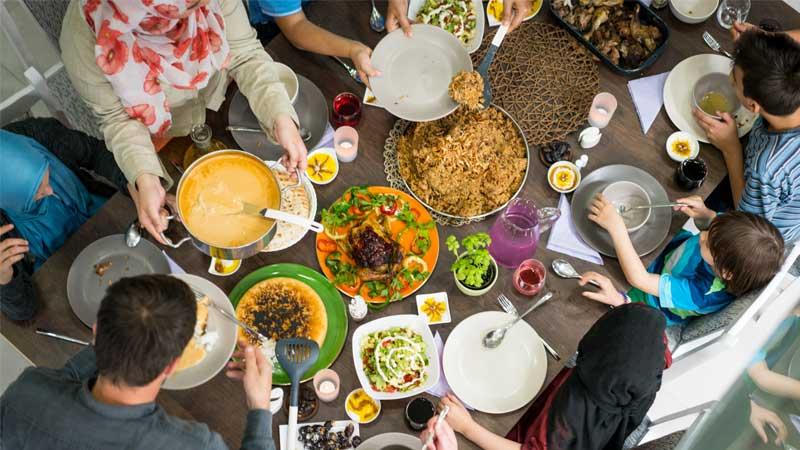 Top view of family and friends eating food around a table