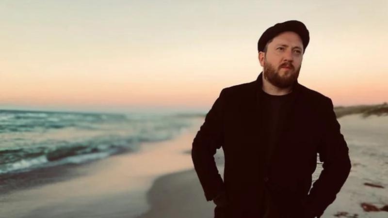 Torfinnur Jákupsson on a beach at sunset