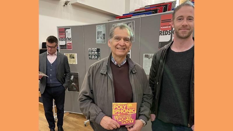 University of Westminster alumnus Allen Sheema poses with a Soho Poly flyer