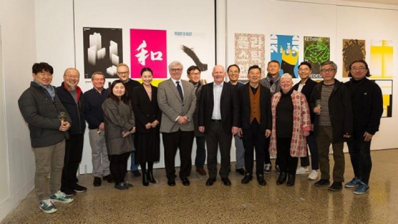 VIDAK members standing next to the art