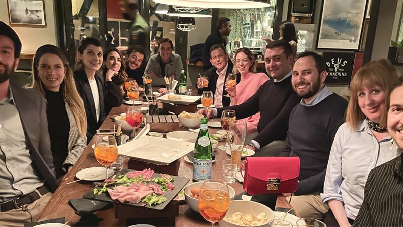 People gathered round table in restaurant at WBS alumni event