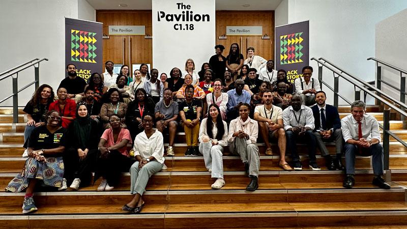 Group photos of conference attendees sat on steps outside The Pavilion.