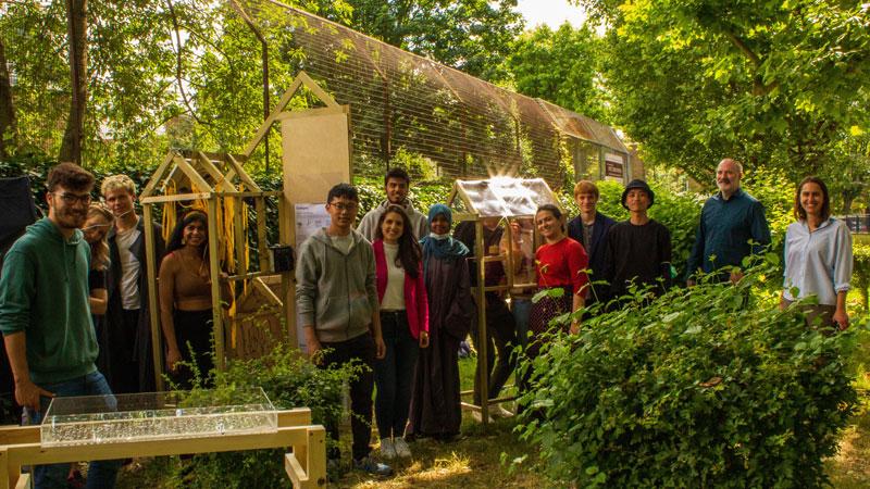 Group of people in green space with architectural designs as part of Climate Demonstrator project