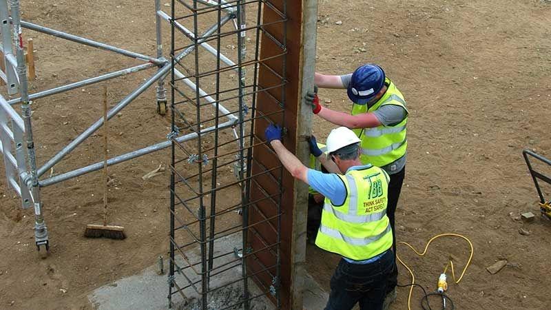 Two workers on a construction site
