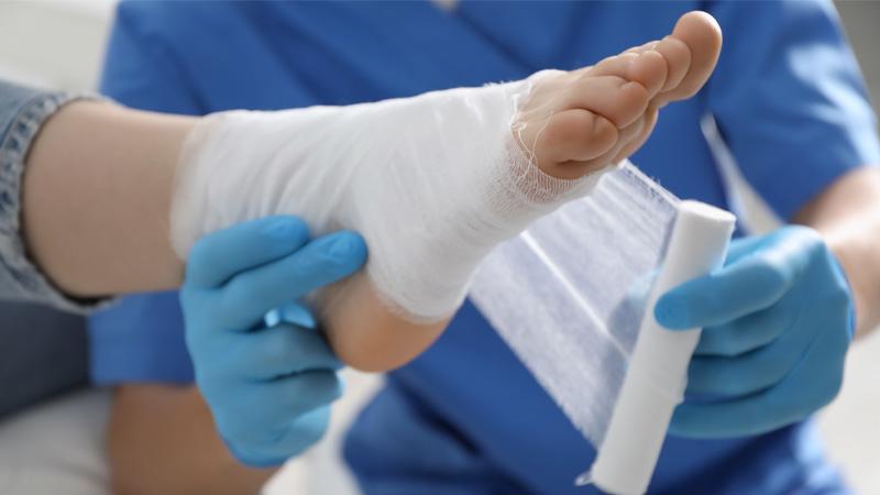 Photo of a medic bandaging a foot