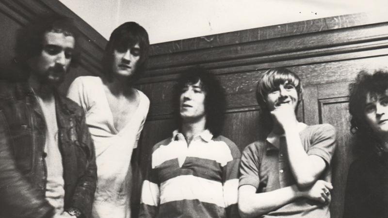 Black and white group photo of band Fleetwood Mac in the dressing room, now the near end of the cafe area, in Westminster's Little Titchfield Street building 