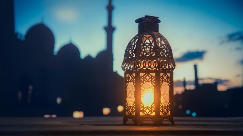 Glowing lantern with mosque in the background