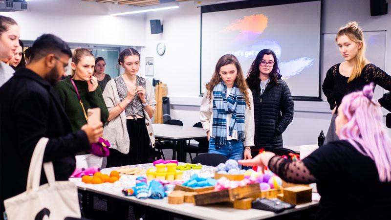 group-of-students-stood-around-bath-bombs-on-table