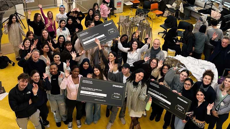 Group photo of participants in Stradling competition, with winners holding large cardboard cheques.