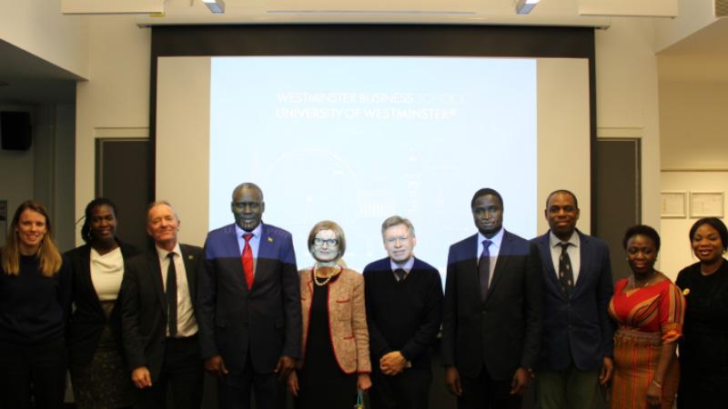 group-stood-together-in-front-of-presentation