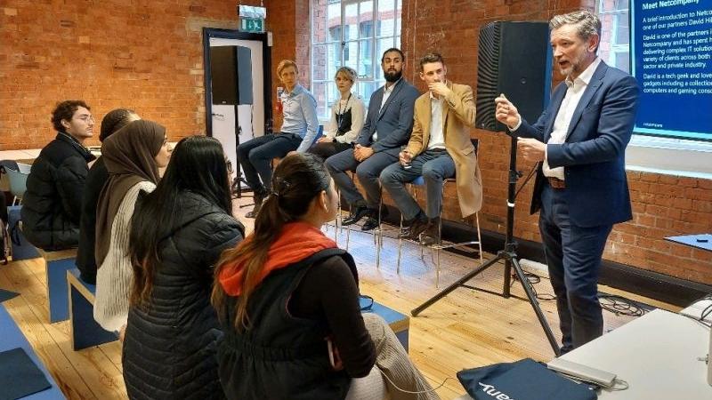 Group of people listening to a man talk