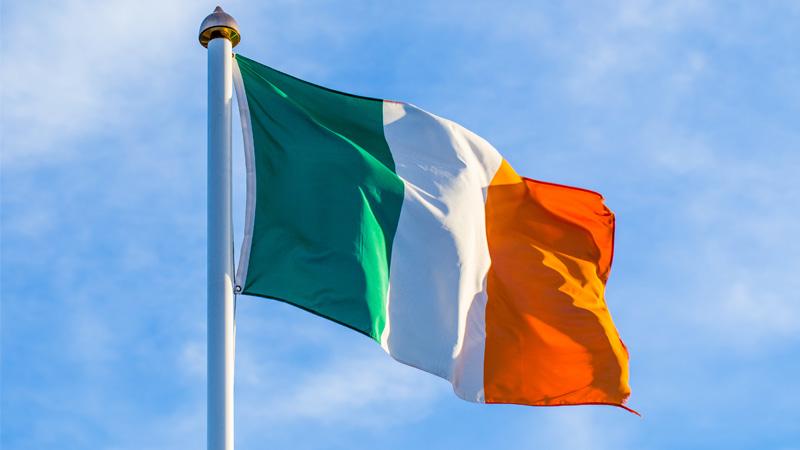 Irish flag on pole waving in the wind